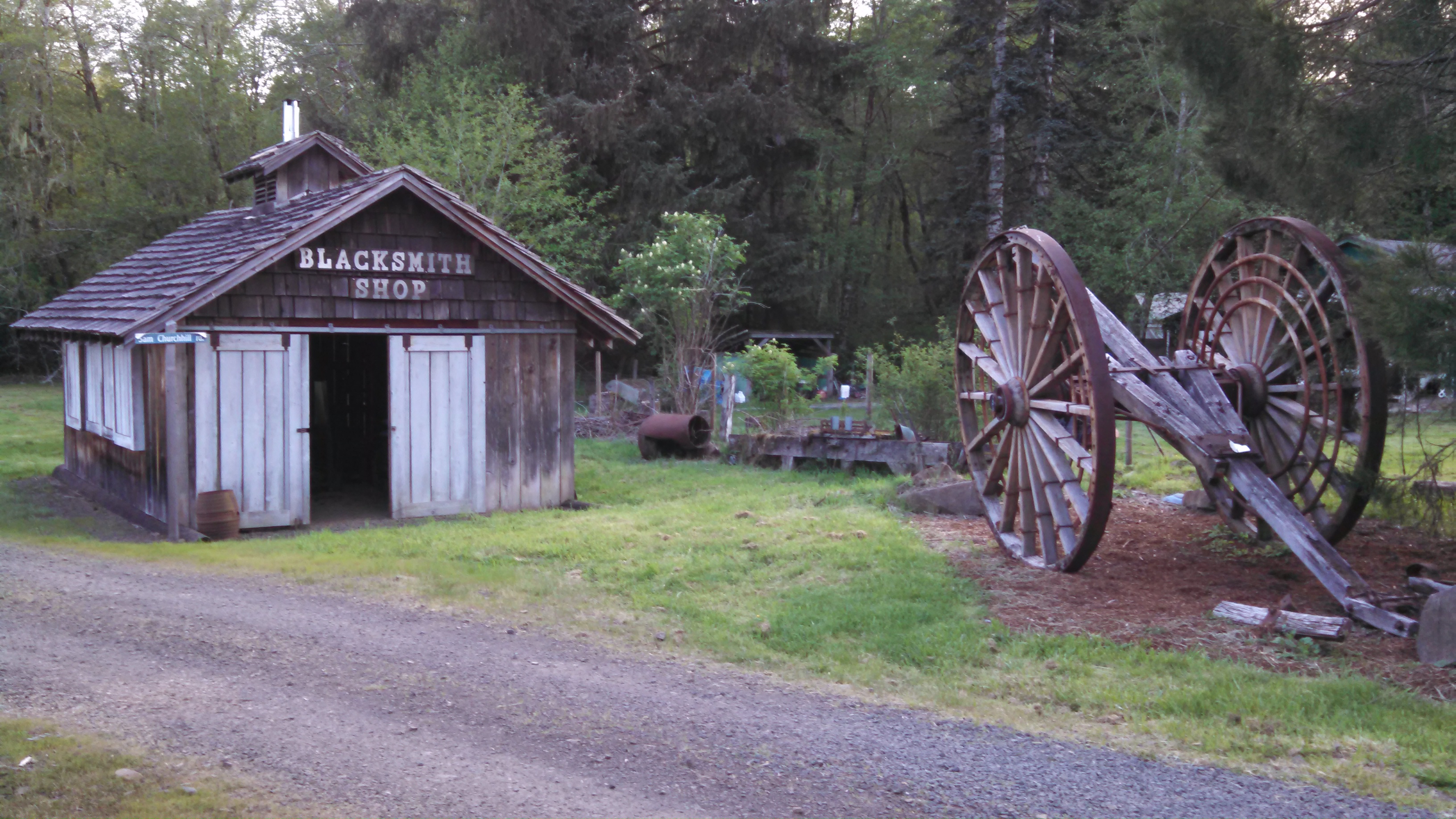 Camp 18 Blacksmith Shop with wagon wheel