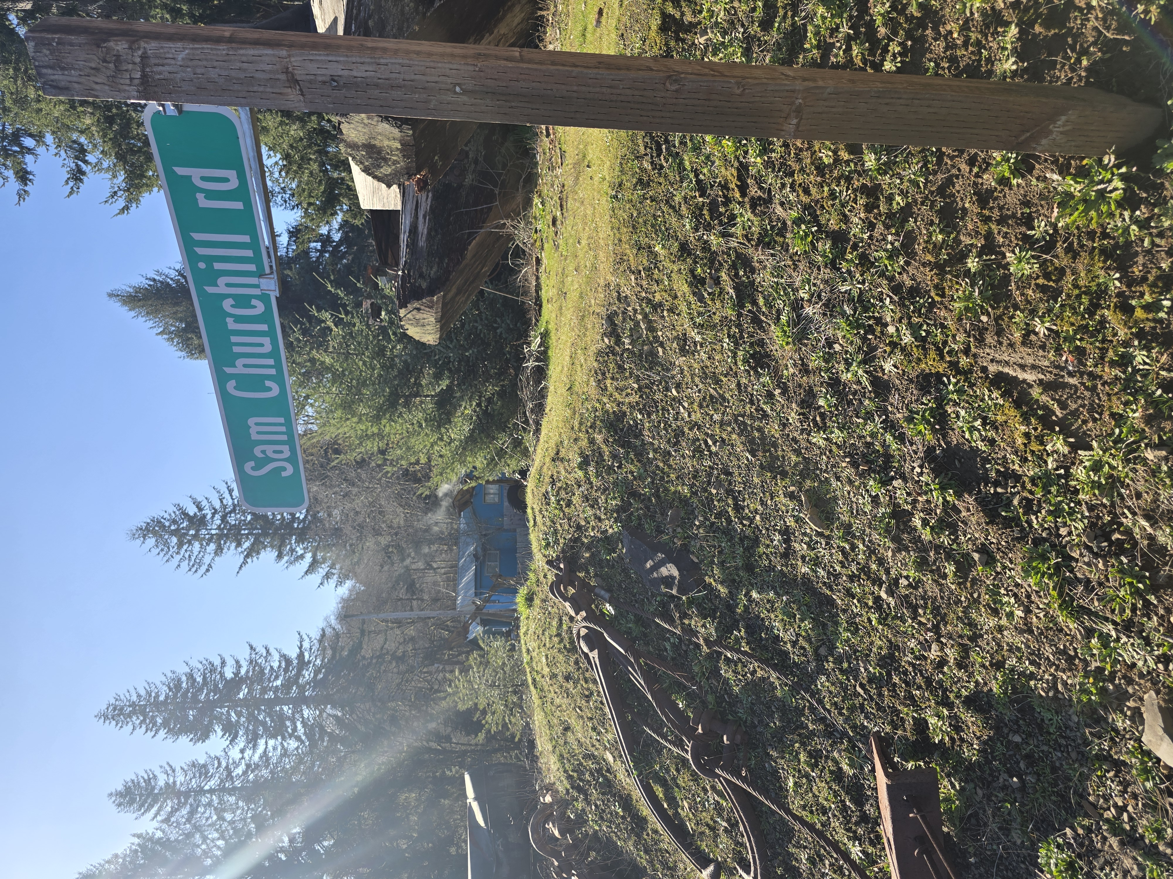 Sam Churchill Road sign at the lower grounds crossroads